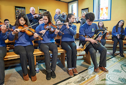 Students playing with teachers Pat Lynch, Gary Shannon and Edel Vaughan, during Mass at the launch of Catholic School's Week in St Flannan's College, Ennis.